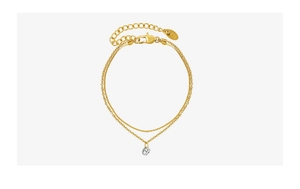Close-up of double-layer 18k gold plated bracelet with faceted zircon pendant and lobster clasp