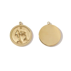 Detailed view of gold stainless steel round pendants with embossed dolphin motif