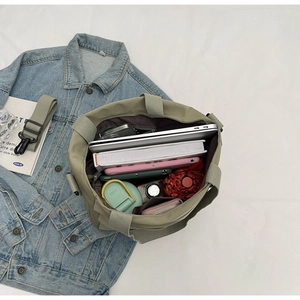 Top view of army green canvas tote showing large capacity for laptop, books and umbrella