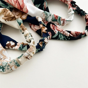 Detailed macro view of the elastic pleated band on floral printed head scarfs for women