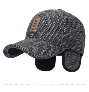 Detail view of winter baseball cap showing foldable earflaps and thick wool texture