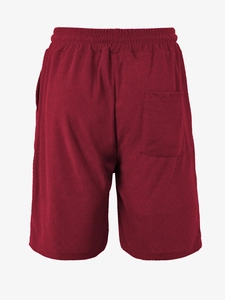 Detail view of burgundy men's casual shorts showing knit waffle texture and back pocket