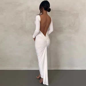 Detail view of white backless maxi dress featuring elegant ruched waist and long sleeves