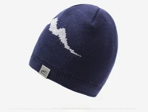 Detail of navy knit beanie with white mountain pattern and a grey woven side label