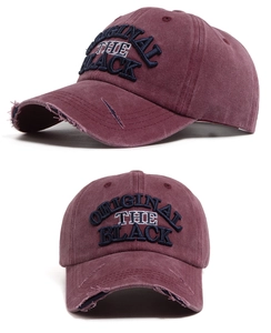 Detail of vintage washed baseball cap with letter embroidery and distressed brim texture