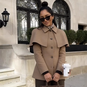 Elegant camel wool cape coat with double-layered collar and buttons in outdoor street style