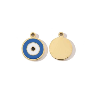 Detailed macro view of gold-plated evil eye charm pendants for jewelry making