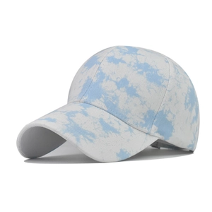 Detailed view of blue and white tie-dye cotton baseball cap with textured twill fabric