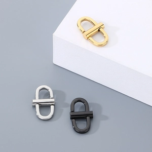 Detailed view of U-shaped stainless steel bag clasps in gold, silver, and black finish