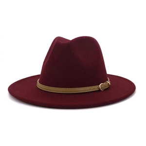 Detail of burgundy fedora hat with khaki leather band and gold buckle accent