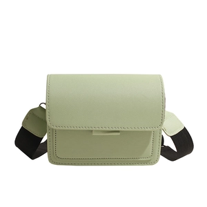 Light green PU leather crossbody bag with wide adjustable woven strap and flap closure