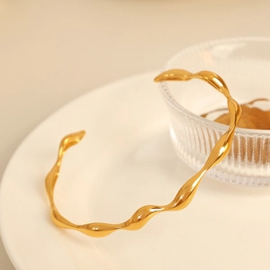 Minimalist gold-plated irregular wavy C-shaped open bangle with polished finish