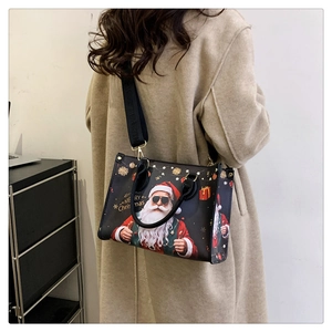 Side view of a large black tote bag with Santa print and Merry Christmas text on a model
