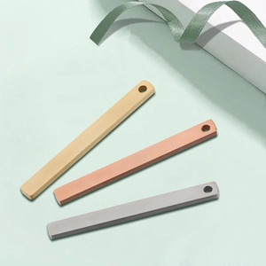 Detailed view of polished gold, rose gold and silver stainless steel bar pendants