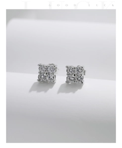Macro detail of square S925 silver stud earrings with four-claw moissanite settings