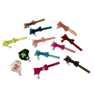 Floral acetate bow hair clips in multiple colors with pearl charms on white background