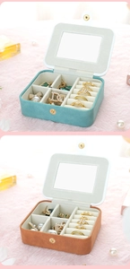 Close-up of suede jewelry box showing inner vanity mirror and ring storage slots