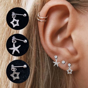 Close-up of silver star and starfish stud earrings set with shiny cubic zirconia accents