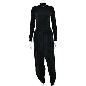 Sexy black long sleeve backless jumpsuit with side slit and ruched detail on model