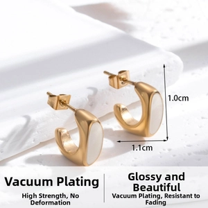 Detailed close-up of C-shaped gold stainless steel earrings with white oval inlay