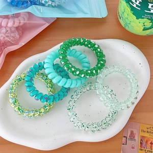 Spiral telephone wire hair ties in vibrant summer gradient colors and floral patterns