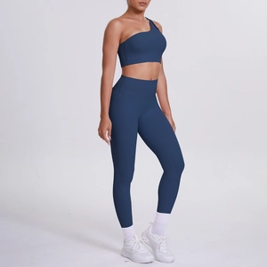 Detail view of one-shoulder navy blue yoga sports bra and high-waisted leggings set