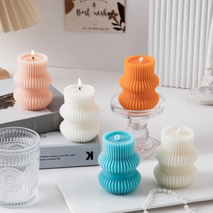 Close-up of geometric pillar scented candles with ribbed texture and warm home decor vibes