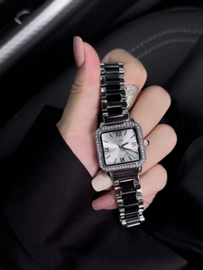 Detail of square quartz watch with crystal bezel and black ceramic silver strap
