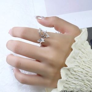 Macro shot of silver butterfly ring with cubic zirconia wings on model's hand