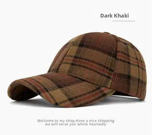 Close-up of dark khaki plaid pattern and thick wool texture on a vintage baseball cap