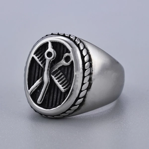 Detailed view of silver stainless steel ring with scissor and comb barber tool carvings