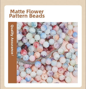 Detailed macro of 8mm matte colorful glass beads with mottled flower patterns for DIY