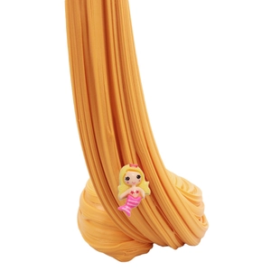 Stretchy orange butter slime with a cute mermaid figurine charm for kids sensory play