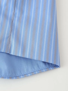 Detailed macro view of the stitching and breathable fabric of the blue striped pajama set