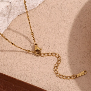 Detail of 18K gold-plated stainless steel necklace with lobster clasp and extender chain