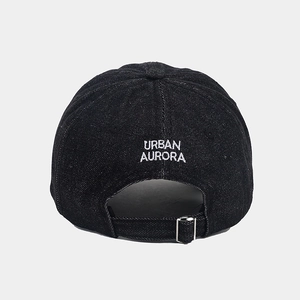 Detail of adjustable silver metal buckle on black denim cap with URBAN AURORA embroidery