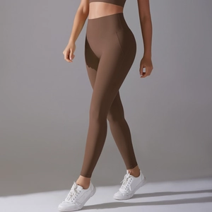 Detail view of high-waist yoga pants in dark brown with seamless shaping and supportive fit