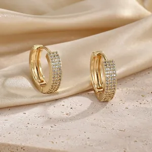 Detail of 18K gold hoop earrings with triple row pave-set cubic zirconia stones