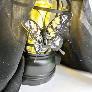 Detail of 3D Halloween butterfly with skull wing pattern on a vintage lantern