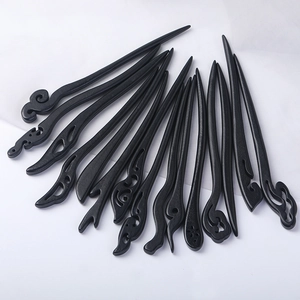 Minimalist black wood hair pins set with traditional Chinese carvings on white background
