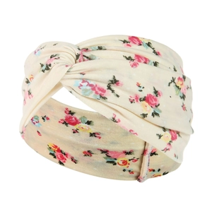 Detail of twisted beige yoga headband featuring a retro floral pattern and cotton texture