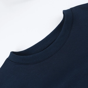 Close-up of navy blue crew neck sweatshirt featuring high-quality ribbed collar detail