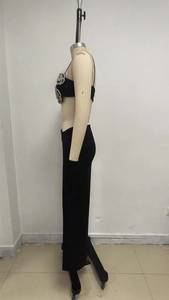 Detail of rhinestone flower decoration on black crop top and matching maxi skirt set