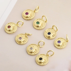 Detailed view of eight colorful zircon evil eye pendants with gold plating and sunburst design