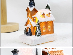 Detail of LED Christmas snow house featuring orange brick walls and sparkling snow texture
