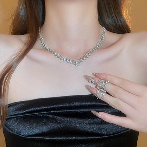 Luxurious silver necklace and tassel ring set with square sparkling crystal diamonds