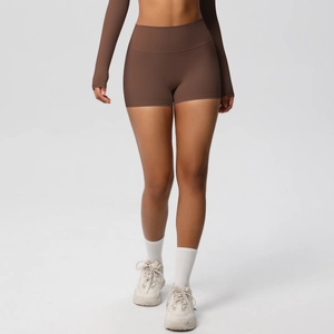 Close-up of high-waisted deep brown gym shorts showing tummy control and seamless compression