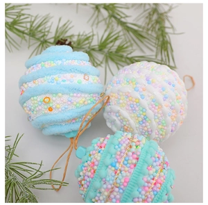 Close-up of 8cm macaron foam Christmas balls with plush ribbons and pine needles