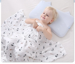 Detail of soft 6-layer cotton gauze baby blanket with bear print and blue cat ear pillow