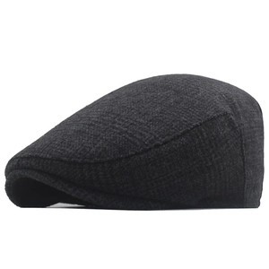 Detail of dark grey ivy cap showing fine plaid texture and wool blend fabric